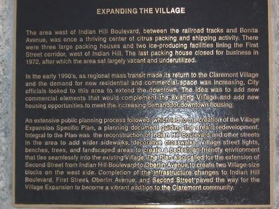 a closeup of a plaque entitled 'Expanding the Village'