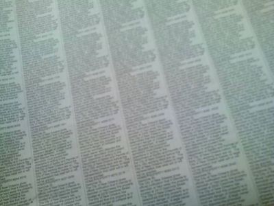 a blurry photo of a densely printed newspaper page